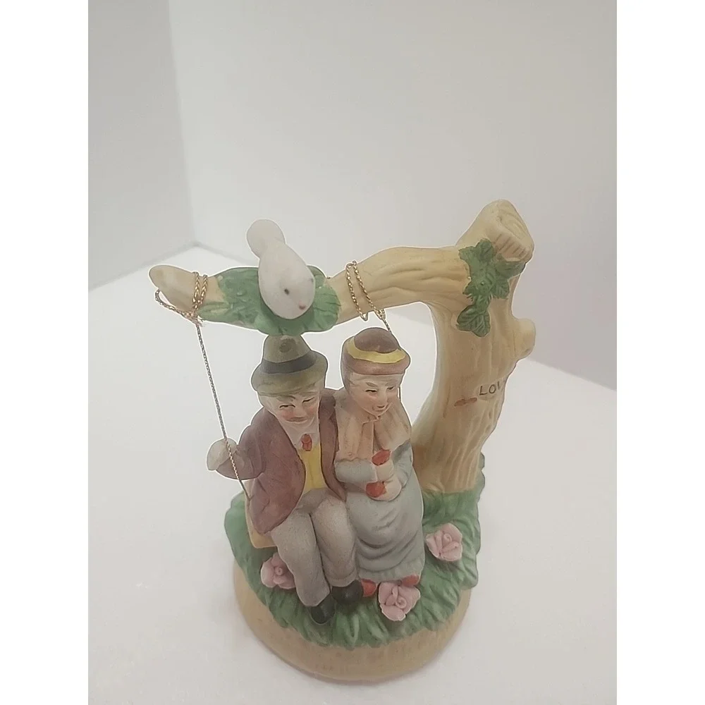 MSR Imports Inc. Porcelain Music Box Elderly Couple on Swing. Writing On Bottom